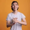 young-cheerful-smiling-asian-man-applauding-2025-02-19-01-34-50-utc-scaled.jpg